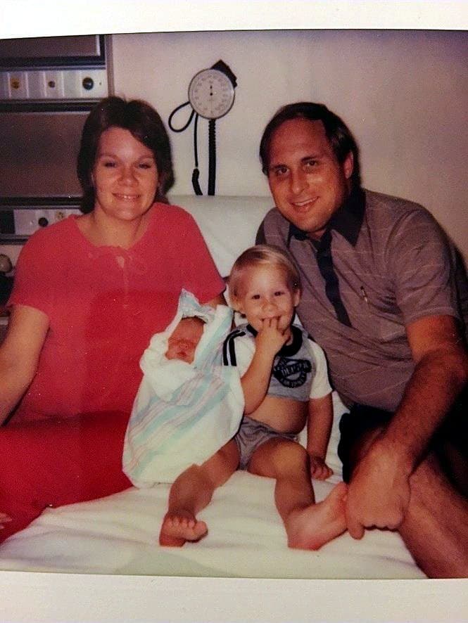 Eve Hess in a hospital bed with newborn Isaac, toddler Garrett and Isaac's dad, Rod