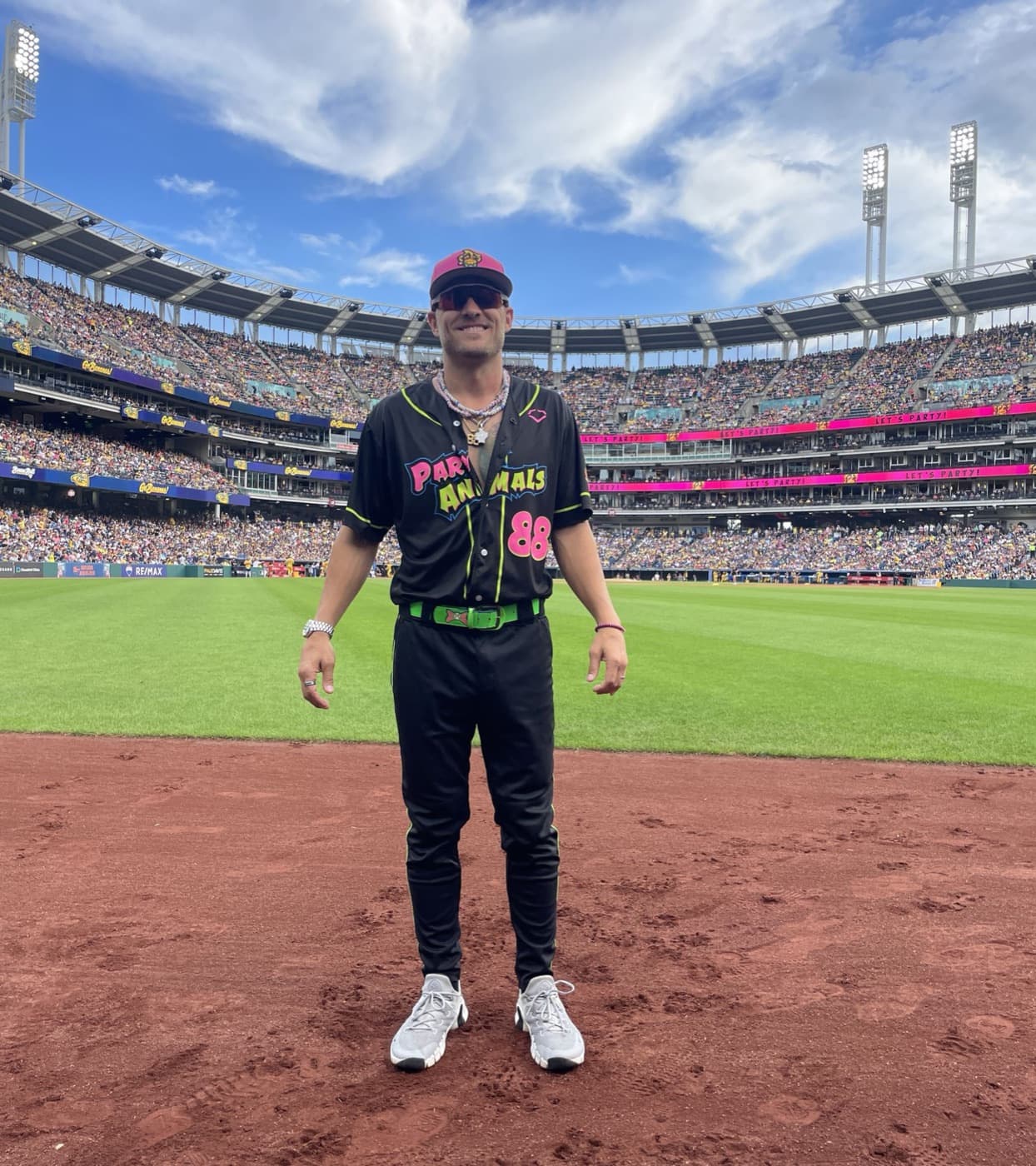 Isaac Hess in his black Party Animals uniform on the field at a packed Progressive Field